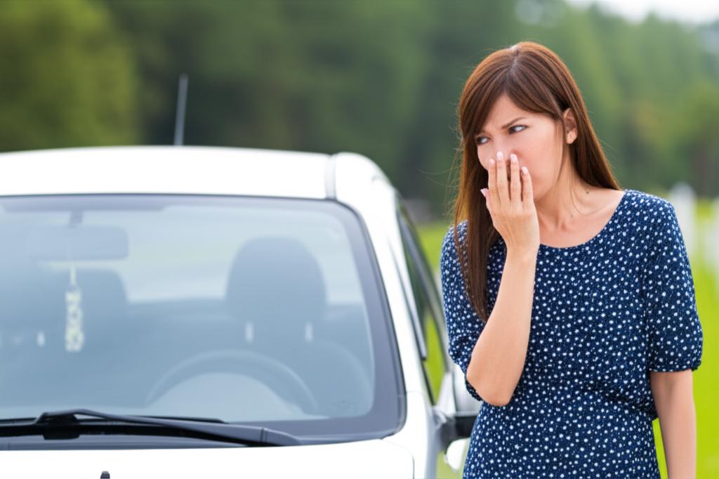 Woman looking at her car worriedly